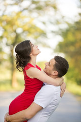 Fototapeta premium Happy young couple embrace in park