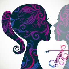 Profile of beautiful young woman decorated with floral patterns.