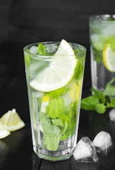 Lemonade in glass with mint, lemon and ice