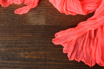 light red scarf closeup on wooden background
