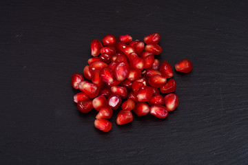 Corn Ripe Pomegranate on dark background.