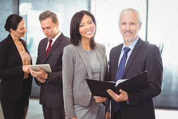 Fototapeta premium Portrait of happy businesspeople with a file
