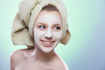 girl smiling with towel and facial mask