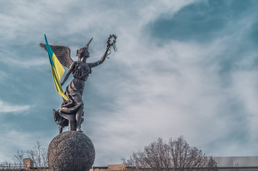 Ukrainian flag in hands of monument in Kharkov
