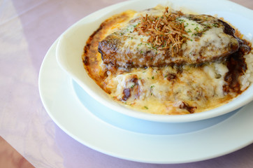 Omelette rice with grilled pork on white plate