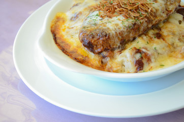 Omelette rice with grilled pork on white plate
