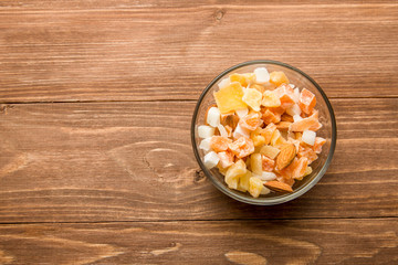 The mixture of nuts and dried fruit in a glass Cup on the table