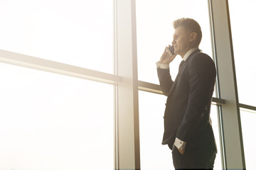 Stylish business man in the background of a large window