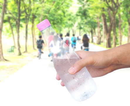 Hand holding plastic water bottle