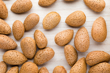 Group of almond nuts with leaves.Wooden background.