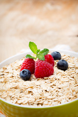 Oatmeal porridge with berries. Raspberries and blueberries.