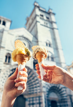 Two hands with ice cream on the San Lorenco Cathedral  backgroun