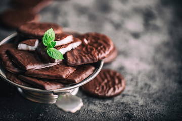 Chocolate peppermint cookies.Mint. Peppermint. Menthol. Black chocolate with peppermint cream. Black chocolate with mint stuffing. Menthol chocolate with mint leaves. Toned images.