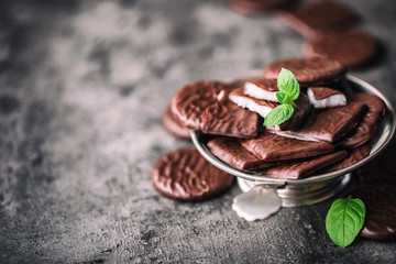 Chocolate peppermint cookies.Mint. Peppermint. Menthol. Black chocolate with peppermint cream. Black chocolate with mint stuffing. Menthol chocolate with mint leaves. Toned images.