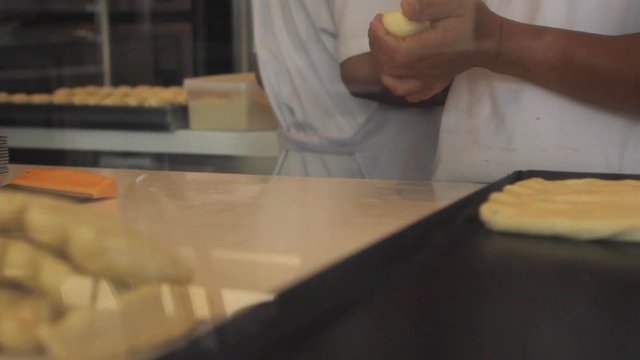 Pastry Chef Working Dough/ Closeup shot of pastry chef hands rolling out dough for patty cake