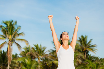 Successful sporty woman enjoying relax after outdoor workout at caribbean beach. Healthy lifestyle on summer vacation concept.