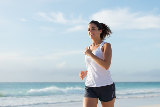 Woman running at beach on summer