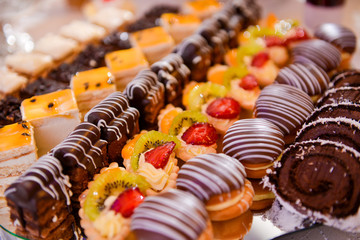 Different type of cakes on a plate and with side light