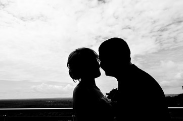 Silhouette couple kissing outdoors