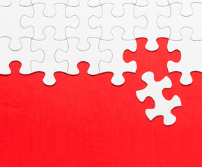 White jigsaw puzzle on red background