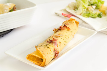 Crepes filled with ham and vegetables