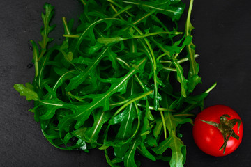 Healthy and diet food: arugula and tomato.