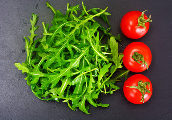 Healthy and diet food: arugula and tomato.