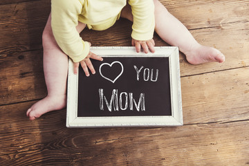 Mothers day composition. Picture frame. Wooden background. Studi