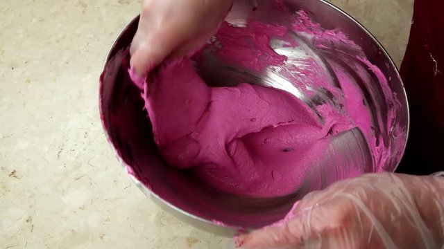 Mixing ingredients for making pink French Macaroons
