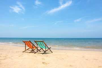 Fototapeta na wymiar Deckchair, chair on the beach in sunshine day.