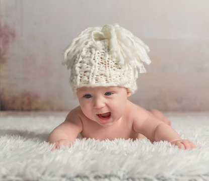funny little baby crawling on woolen blanket