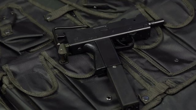 Submachine gun against the background of the vest