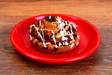 Homemade Cakes: Cake on Plate with Nuts, Chocolate and Raisins.