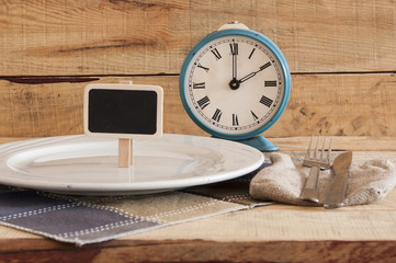 Fototapeta na wymiar retro alarm clock on a plate