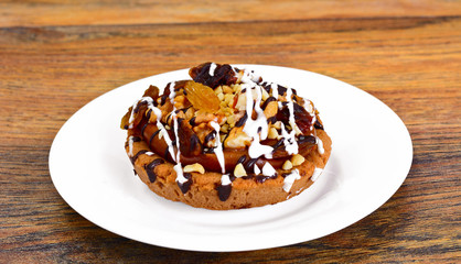 Homemade Cakes: Cake on Plate with Nuts, Chocolate and Raisins.