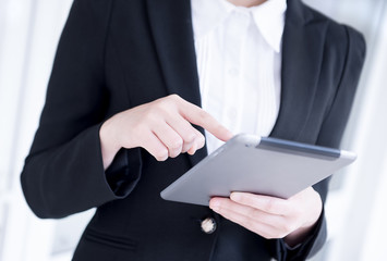 Businesswoman playing tablet- Hand Focused