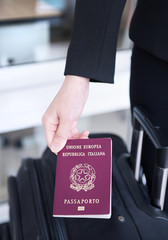 Hand holding Italy passport, ready to travel