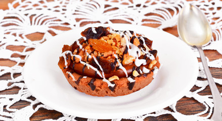 Homemade Cakes: Cake on Plate with Nuts, Chocolate and Raisins.