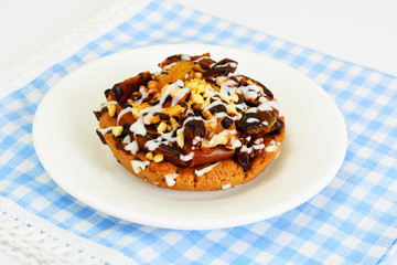 Homemade Cakes: Cake on Plate with Nuts, Chocolate and Raisins.