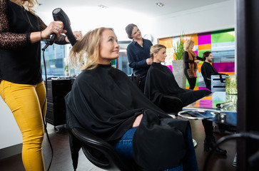 Hairdressers Setting Client's Hair In Salon