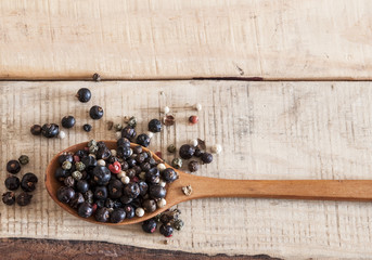 whole peppercorns on wooden spoons