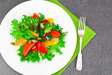 Healthy and diet food: Lettuce, tomato, pepper, seeds, oil, salt