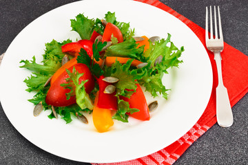 Healthy and diet food: Lettuce, tomato, pepper, seeds, oil, salt
