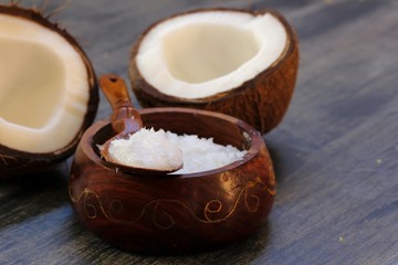 Fototapeta na wymiar Coconut oil in a woodeen bowl, selective focus
