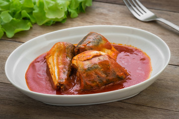 Canned fish in tomato sauce on plate