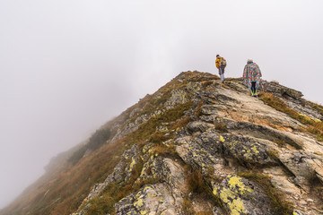 Hiking Trail with Tourists on the Hill in the Mountains in the Mist