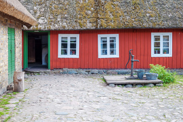 Fototapeta na wymiar fragment of village house and water pump