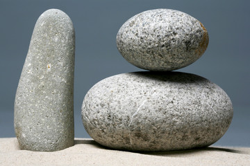 Stack of stones - pebbles on grey background