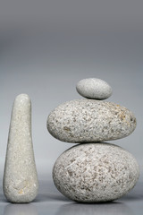 Fototapeta na wymiar Stack of stones - pebbles on grey background