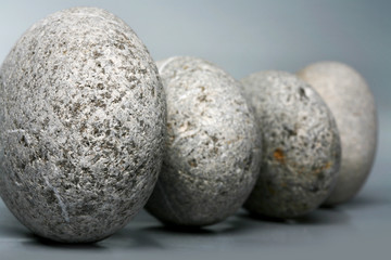 Naklejka na ściany i meble Stack of stones - pebbles on grey background